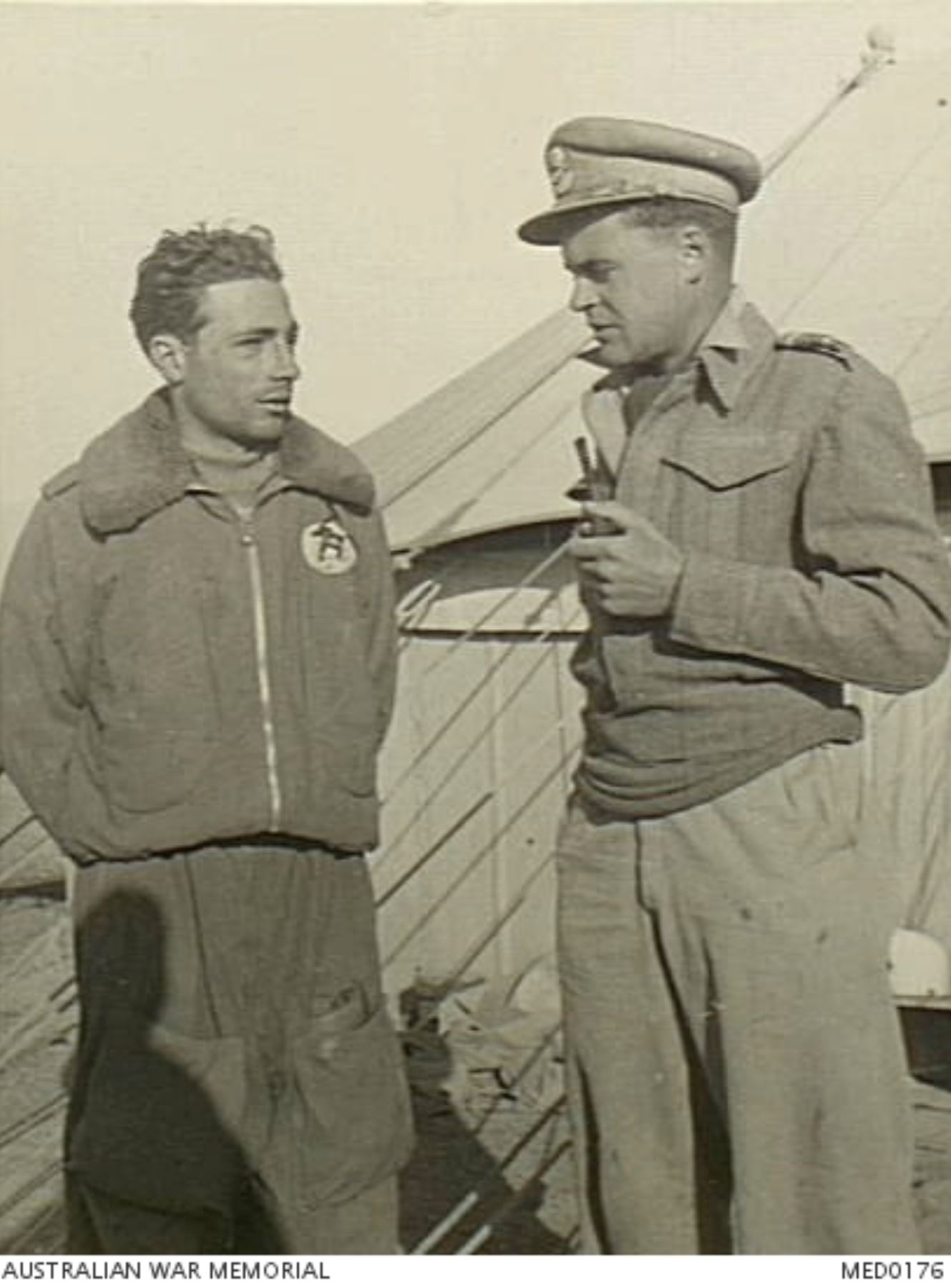 RAF Intelligence Officer interrogates an Italian Black Cat fighter pilot who survived a midair AWM MED0176