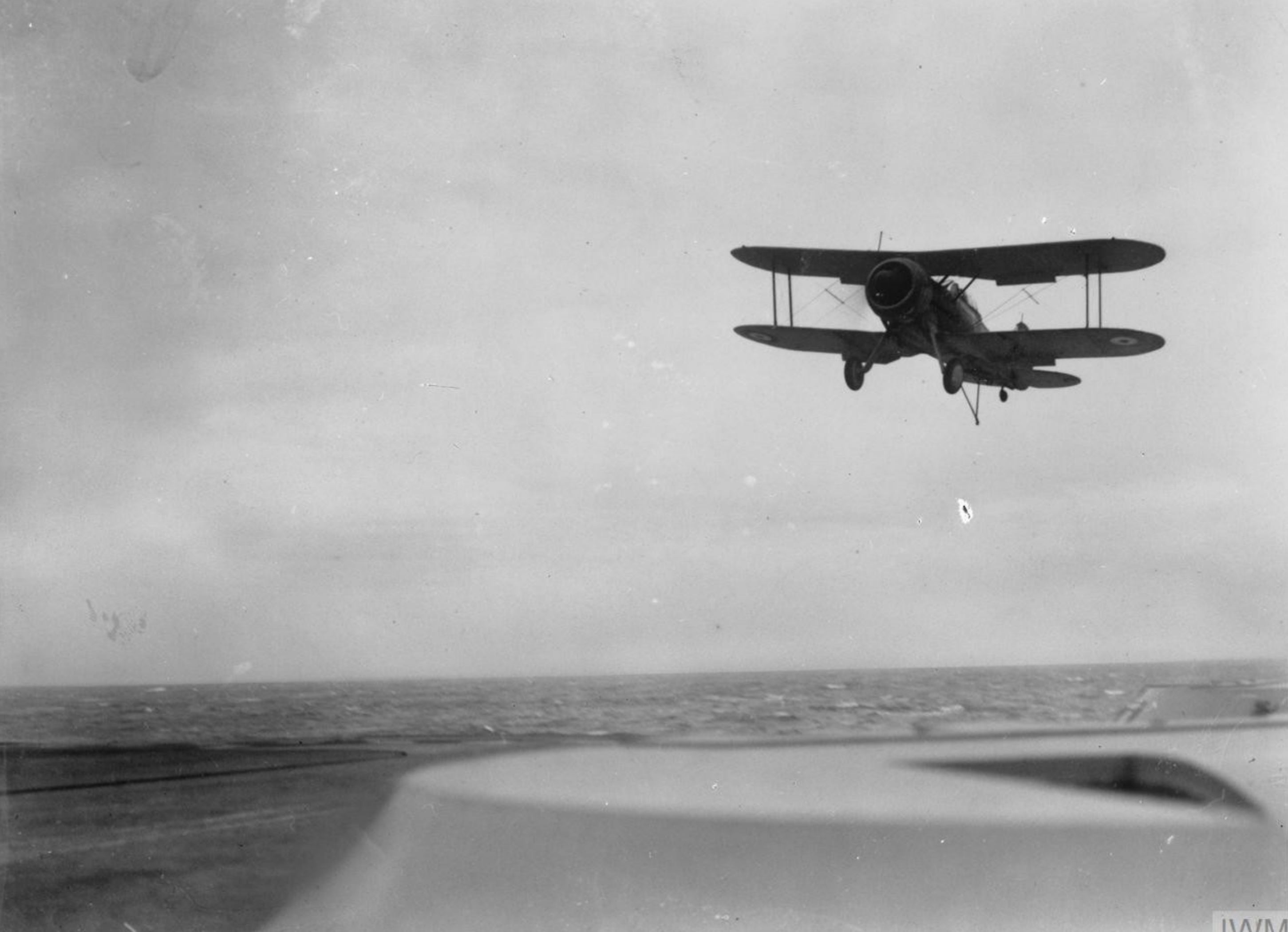 Fleet Air Arm Gloster Sea Gladiator from NAS Hatson landing aboard HMS Victorious IWM A6974