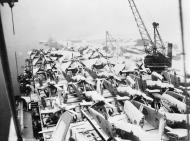 Asisbiz RN escort carrier HMS Ruler docked with her flight deck packed with snow covered aircraft IWM A28797
