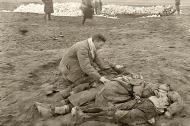 Asisbiz German atrocities Grief striken father cant beleive the sight of his murdered family by German soldiers 02