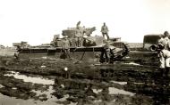 Asisbiz German soldiers pose for a photo against a Soviet T 35 tank abandoned after a battle 01