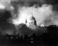 Asisbiz 08 Raging fires silhouette St Pauls Cathedral after a lone German bomber dropped incendiary bombs 1st Sep 940 02