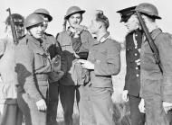 Asisbiz Captured Luftwaffe bomber crewman is given a drink of water after baling out of his aircraft Aug 1940 IWM KY10265