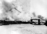 Asisbiz View of the Thames River and London Tower Bridge with smoke from fires after a bombing raid 1940 01