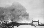 Asisbiz View of the Thames River and London Tower Bridge with smoke from fires after a bombing raid 1940 02