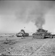 Asisbiz British Crusader tank passes a burning German PzKpfw IV tank 27 Nov 1941 IWM E6752