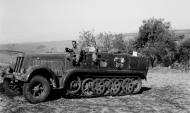 Asisbiz Captured SdKfz 7 half track being driven by a British soldier Sicily 1943 NAM197503631444L