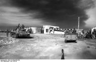 Asisbiz German Cmd GenLt Erwin Rommel n Fritz Bayerlein standing in a Horch Kfz 15 with a Panzer III Tobruk Jun 1942 01