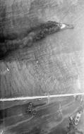 Asisbiz Recon photo Italian tanker Portofino on fire in Benghazi harbour after USAAF raid 6th Nov 1942 IWM CM5908