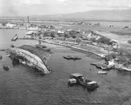 Asisbiz Aerial View Showing Salvage of the USS Oklahoma (BB 37) Pearl Harbor Hawaii 19th Mar 1943 80 G 300131