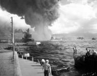 Asisbiz USS California (BB 44) is at left listing to port after receiving two torpedo hits and center is USS Maryland (BB 46) 80 G 32640