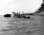 Asisbiz USS Oklahoma (BB 37) capsized hull with USS Maryland (BB 46) right at Pearl Harbor 7th Dec 1941 80 G 32453