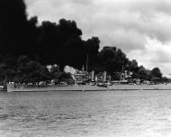 Asisbiz USS Phoenix (CL 46) off Ford Island passes the burning USS West Virginia (BB 48) and USS Arizona (BB 39) 7th Dec 1941 NH 50766