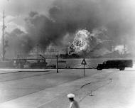 Asisbiz USS Shaw (DD 373) in floating drydock burning as a result of the Japanese bombing on Pearl Harbor 7th Dec 1941 NH 97417