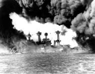Asisbiz USS West Virginia (BB 48) sunken at left and Tennessee (BB 43) shrouded in smoke Pearl Harbor 7th Dec 1941 NH 94378