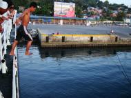 Asisbiz Youngster jumping off the Batangas ferry for coins Calapan Port Oriental Mindoro Philippines 2009 01