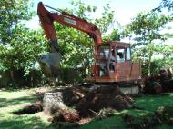 Asisbiz Using a Hitachi Backhoe to remove coco tree stumps Tabinay Philippines 04