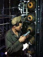Asisbiz Ordanance guy inserts a fuse into a 100lb bomb in the bomb bay of a B 24 Liberator England 1944 02