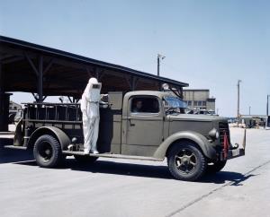 Asisbiz Fire Fighting unit in a Asbestos Suit with a US Army Mack Class 125 airfield crash truck 1942 01