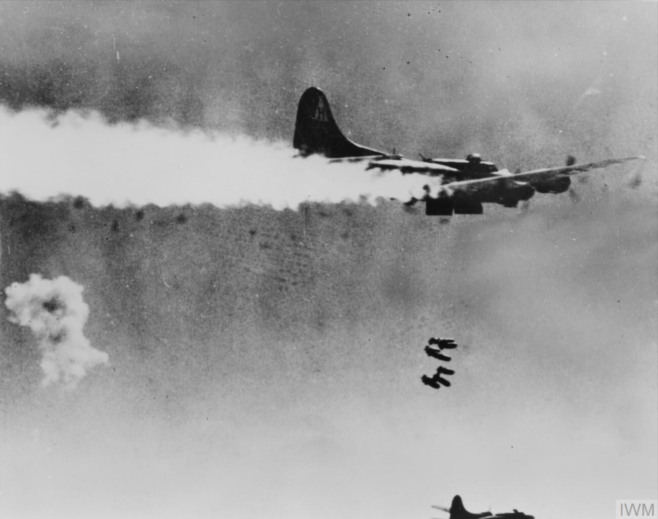 Boeing B-17F Fortress 8AF 306BG over the Berlin drop zone trailing smoke but maintains formation FRE4349