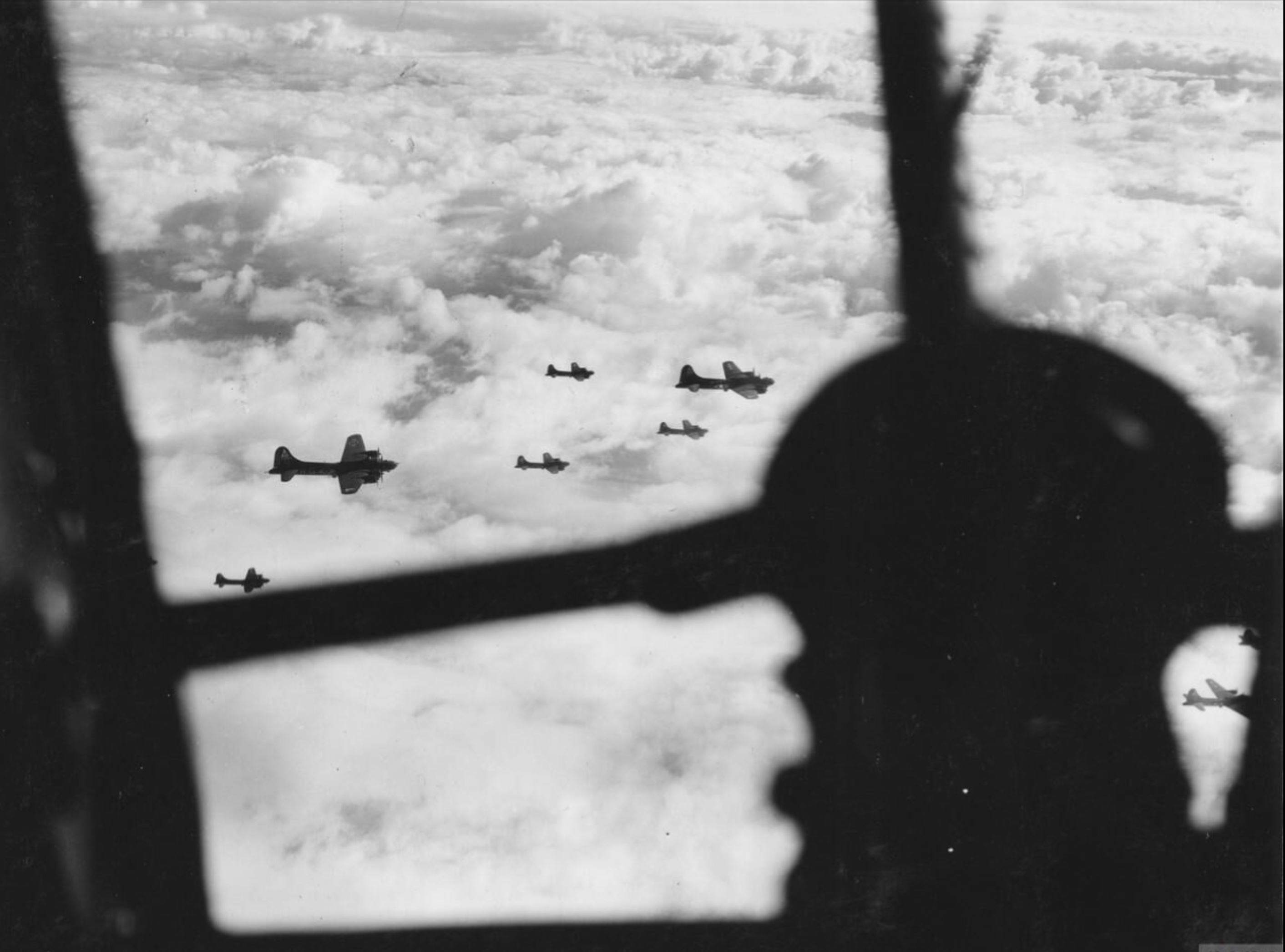 Boeing B-17F Fortresses 8AF 306th Bomb Group fly above the cloud cover in loose formation FRE4345