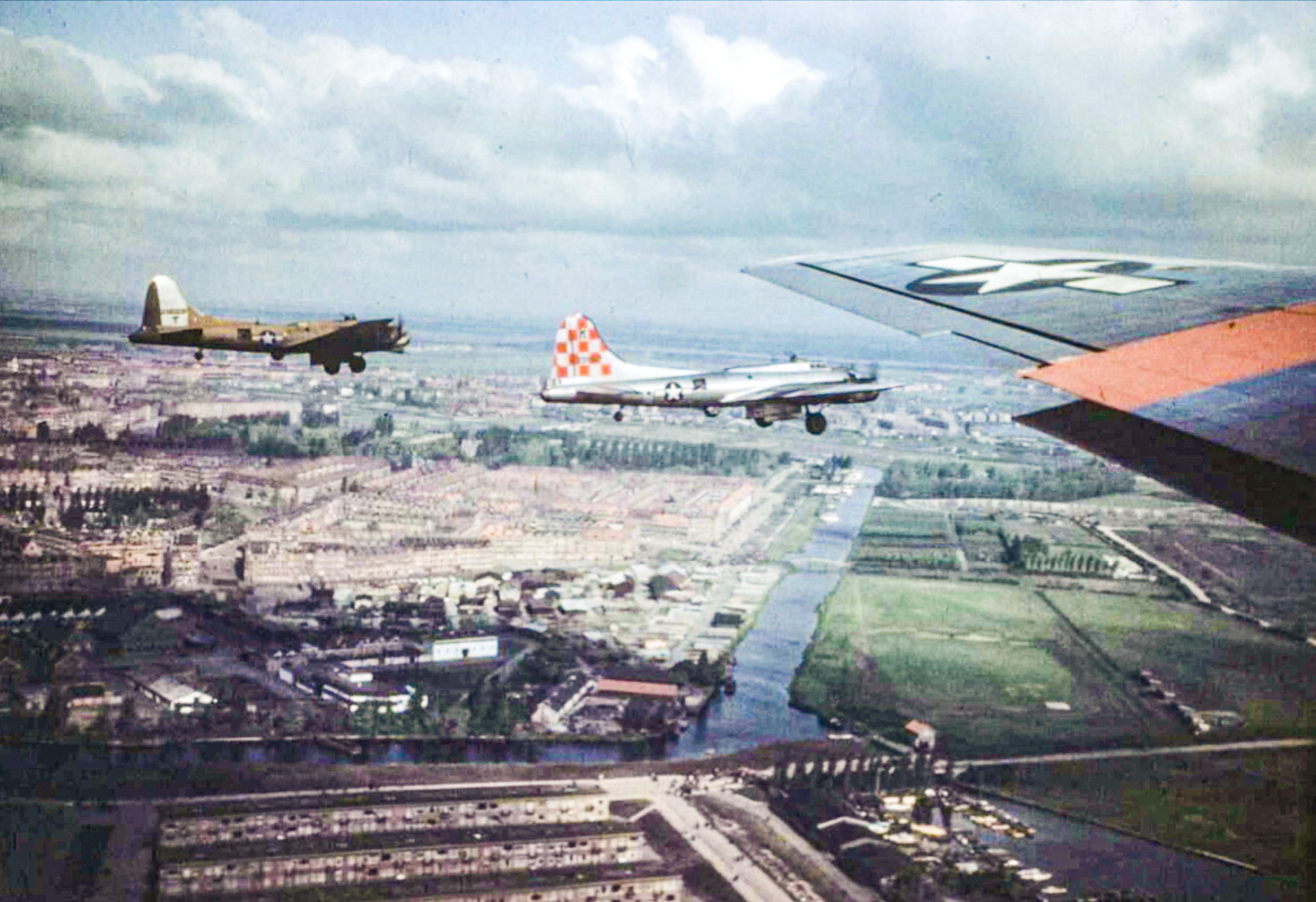 Boeing B-17 Fortresses 8AF 385BG fly low over a Dutch town during a food mission Apr 1945 FRE6450