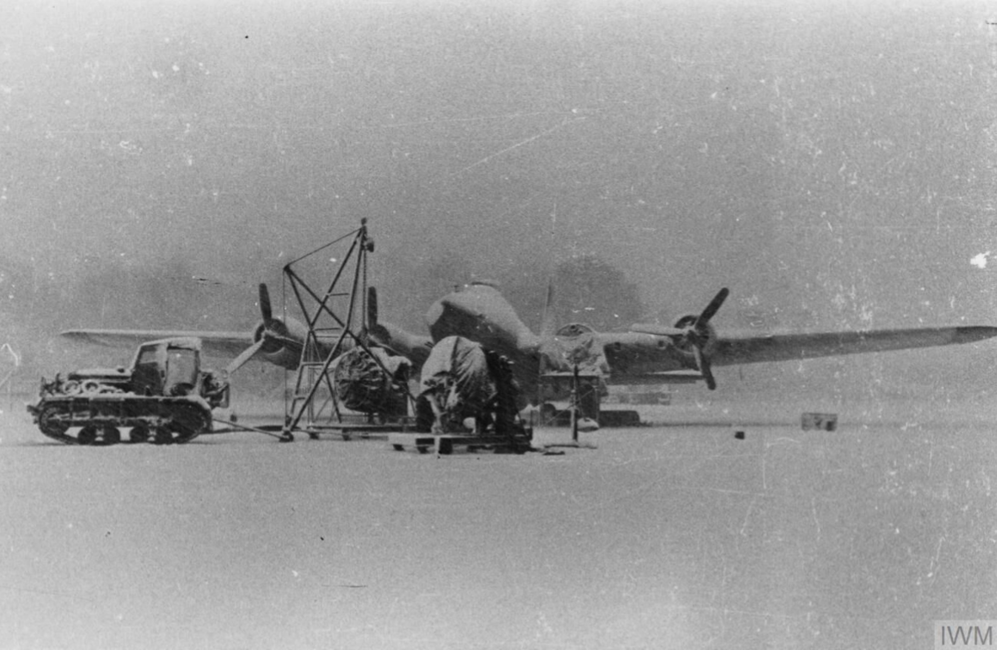 Boeing B 17G Fortress 8AF 398BG under repair with a Cletrac left due to heavy snow FRE8039