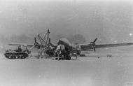 Asisbiz Boeing B 17G Fortress 8AF 398BG under repair with a Cletrac left due to heavy snow FRE8039