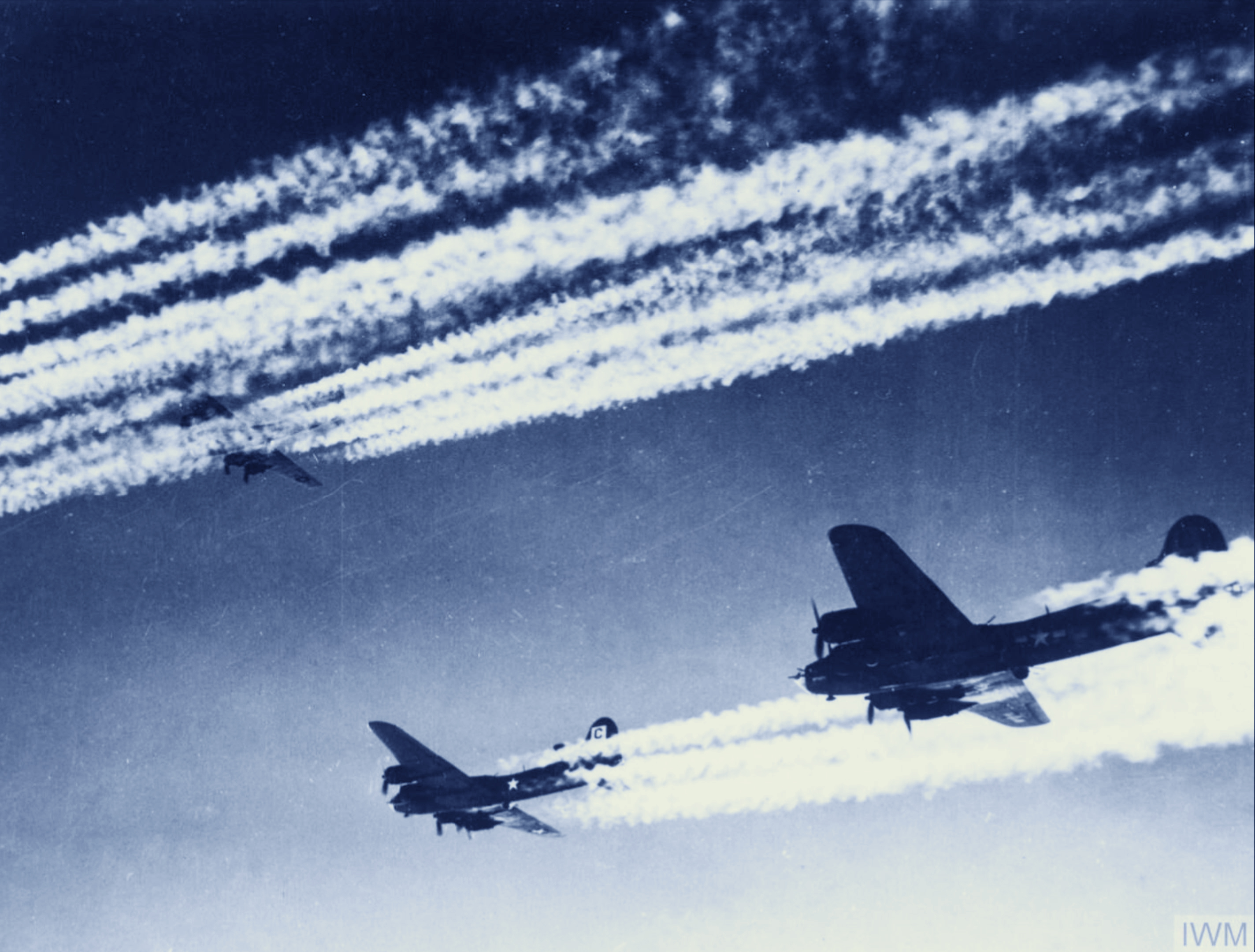 Boeing B-17 Fortresses 8AF 96BG leave contrails behind as they fly in formation during a mission FRE3972