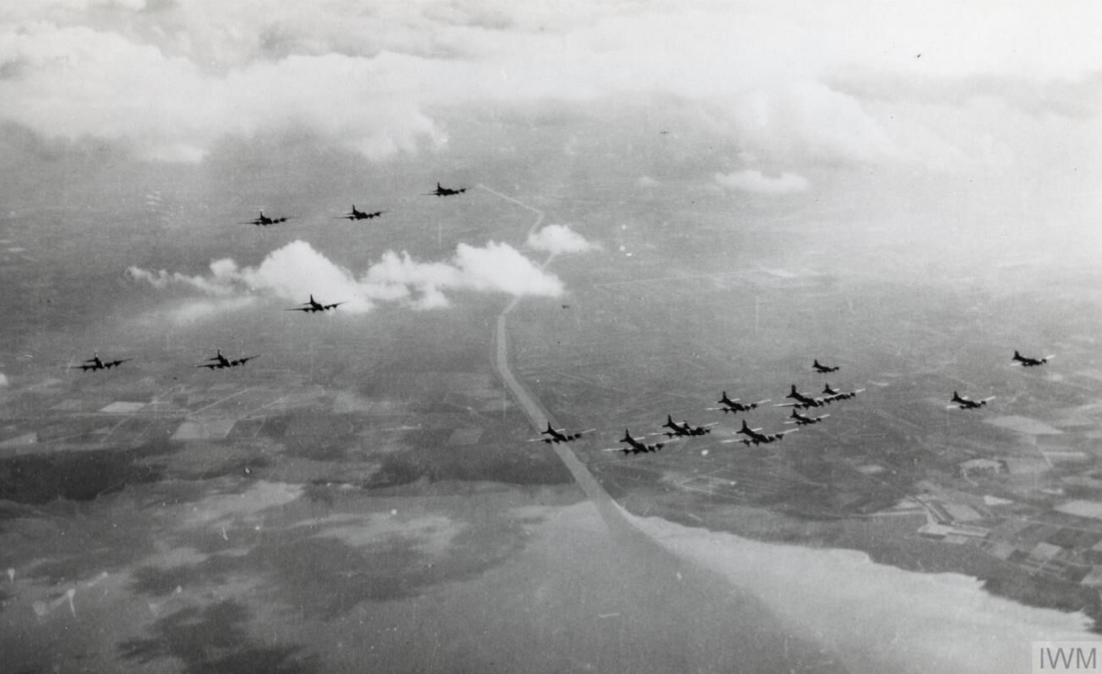 Boeing B-17 Fortresses leave the coast flying in their Box formation FRE14443