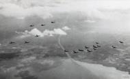 Asisbiz Boeing B 17 Fortresses leave the coast flying in their Box formation FRE14443