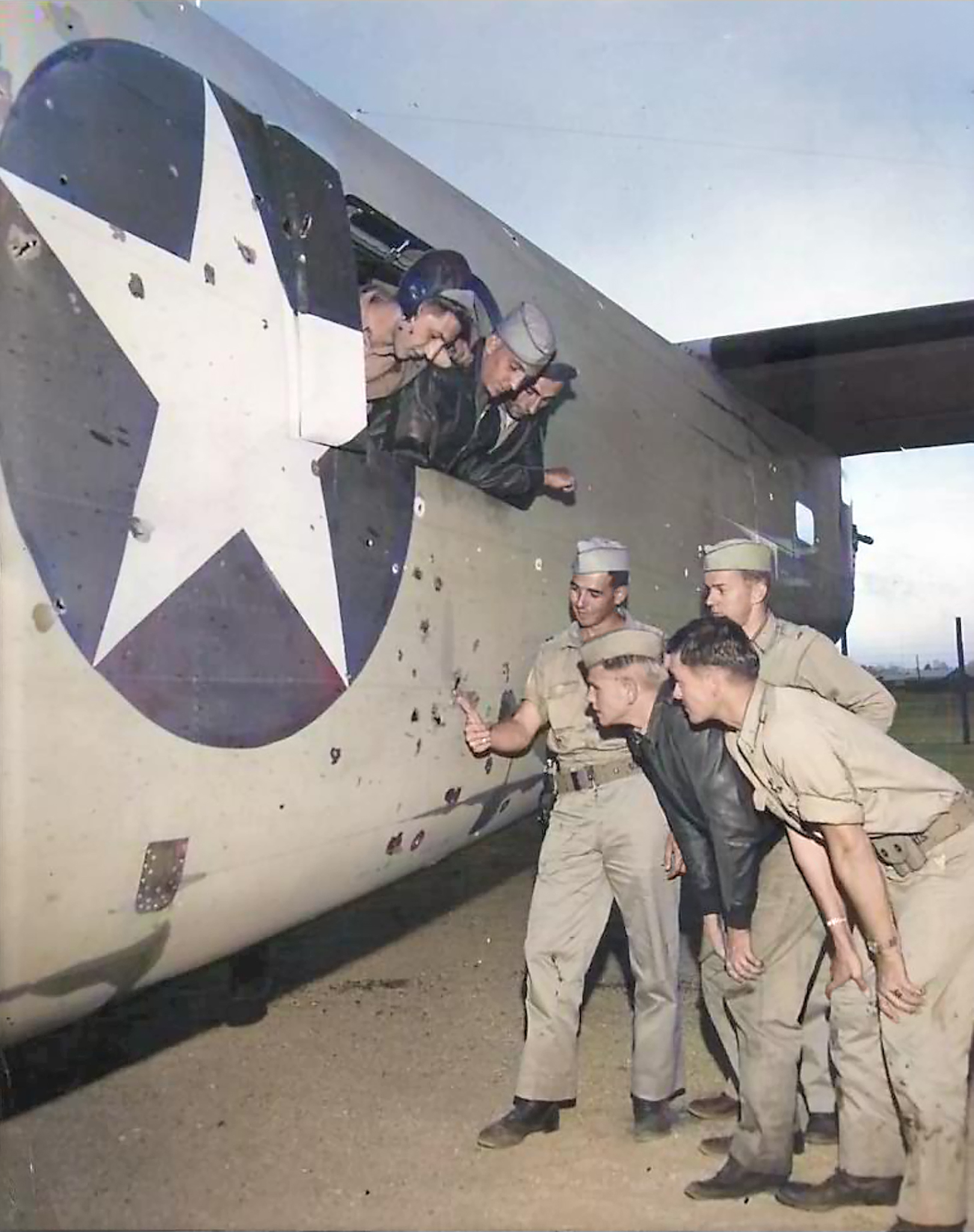 Consolidated B-24D Liberator 15AF 9AF 376BG514BS crew inspecting holes in their B-24 after a mission North Africa 1942 01