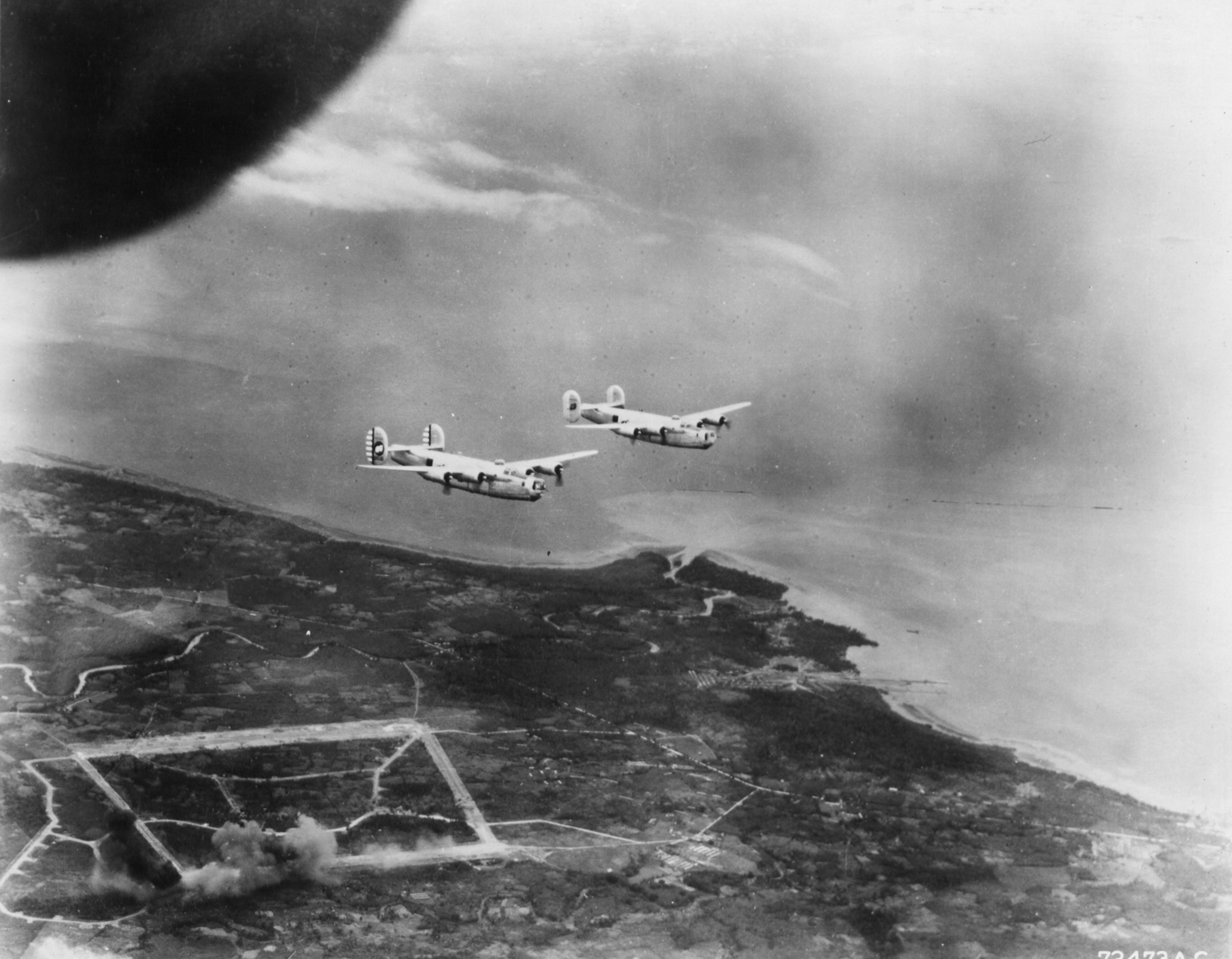 Consolidated B-24 Liberator 5AF 43BG65BS head back to base after hiting a Jap airfield 1944 01