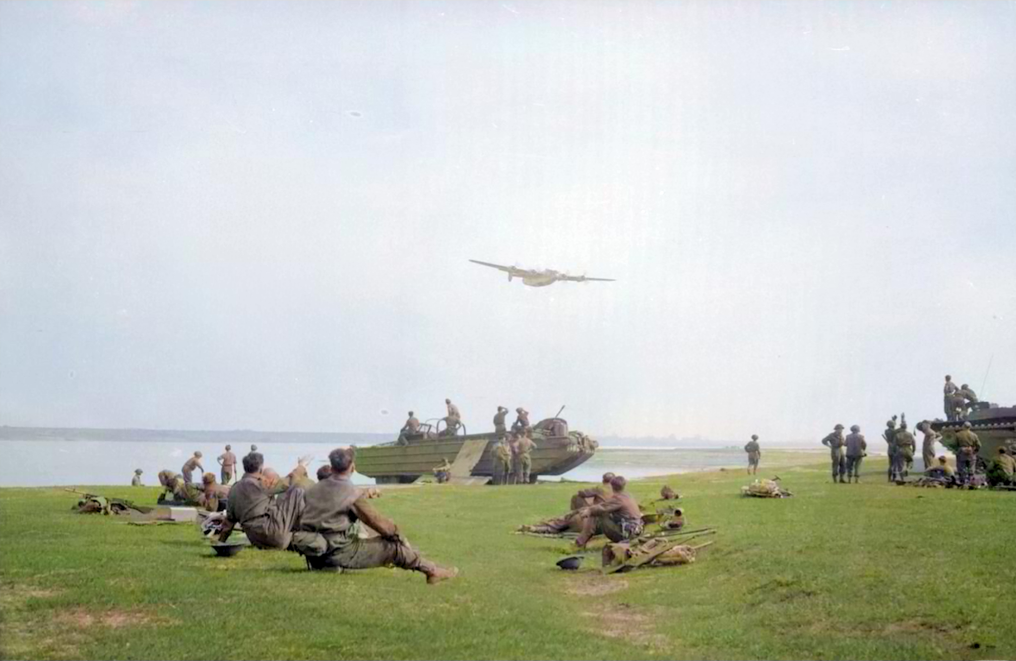 American Liberator bomber flies low over British troops during the Rhine crossing 24th Mar 1945 IWM 01