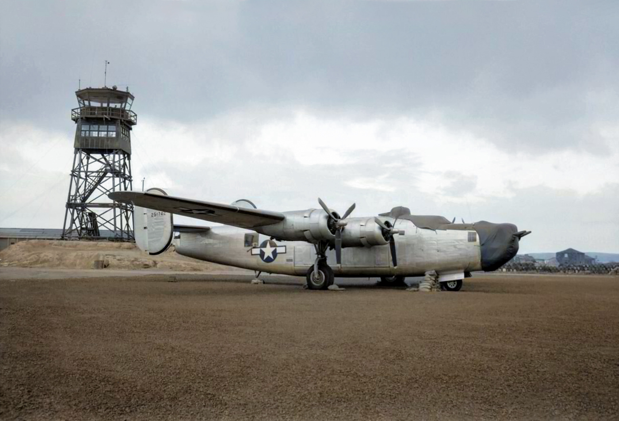 Consolidated B-24J Liberator of the USAAF parked by the control tower at Lagens while in transit IWM CA99