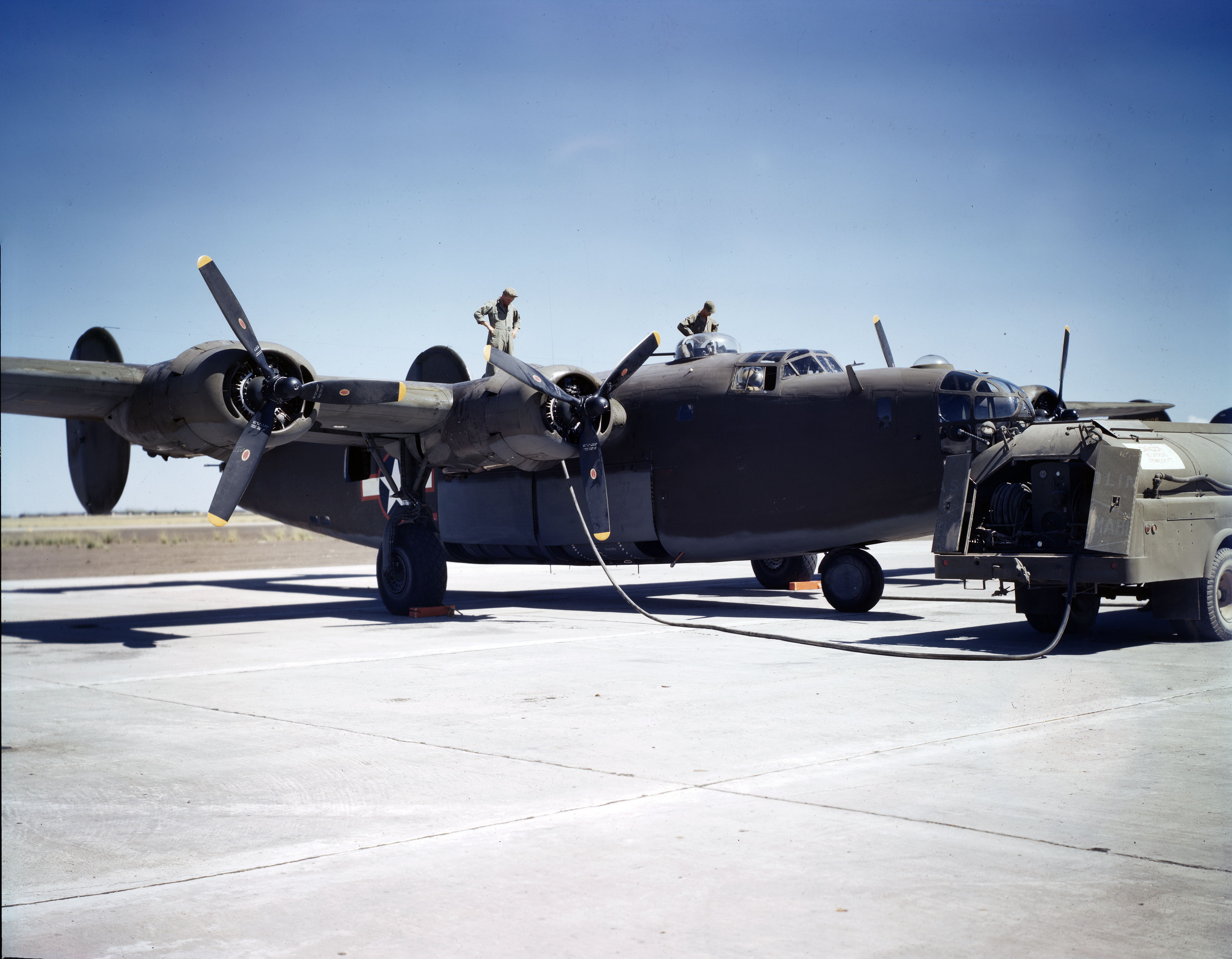 WWII color photo of USAAF Consolidated B-24D Liberator training aircraft being refueled in USA 1943 01