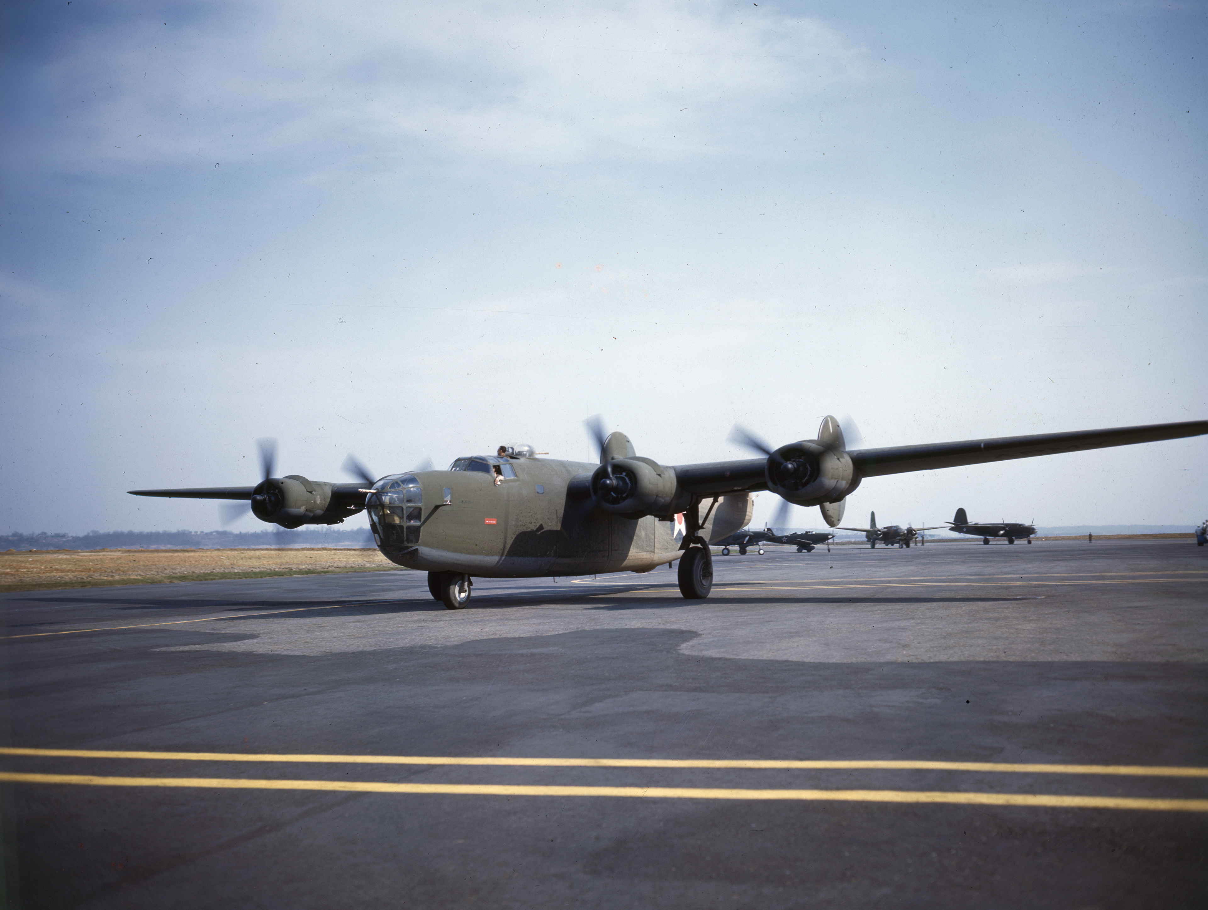 WWII color photo of early USAAF Consolidated B-24D Liberator training aircraft taxiing in USA 1941 01