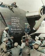 Asisbiz Small boy uses the side of a B-24 as a blackboard to give US airmen a lesson in Italian 1944 01