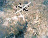 Asisbiz Target 15th Air Force 55BW B-24 Liberator over a enemy rail yard instillation ASC1