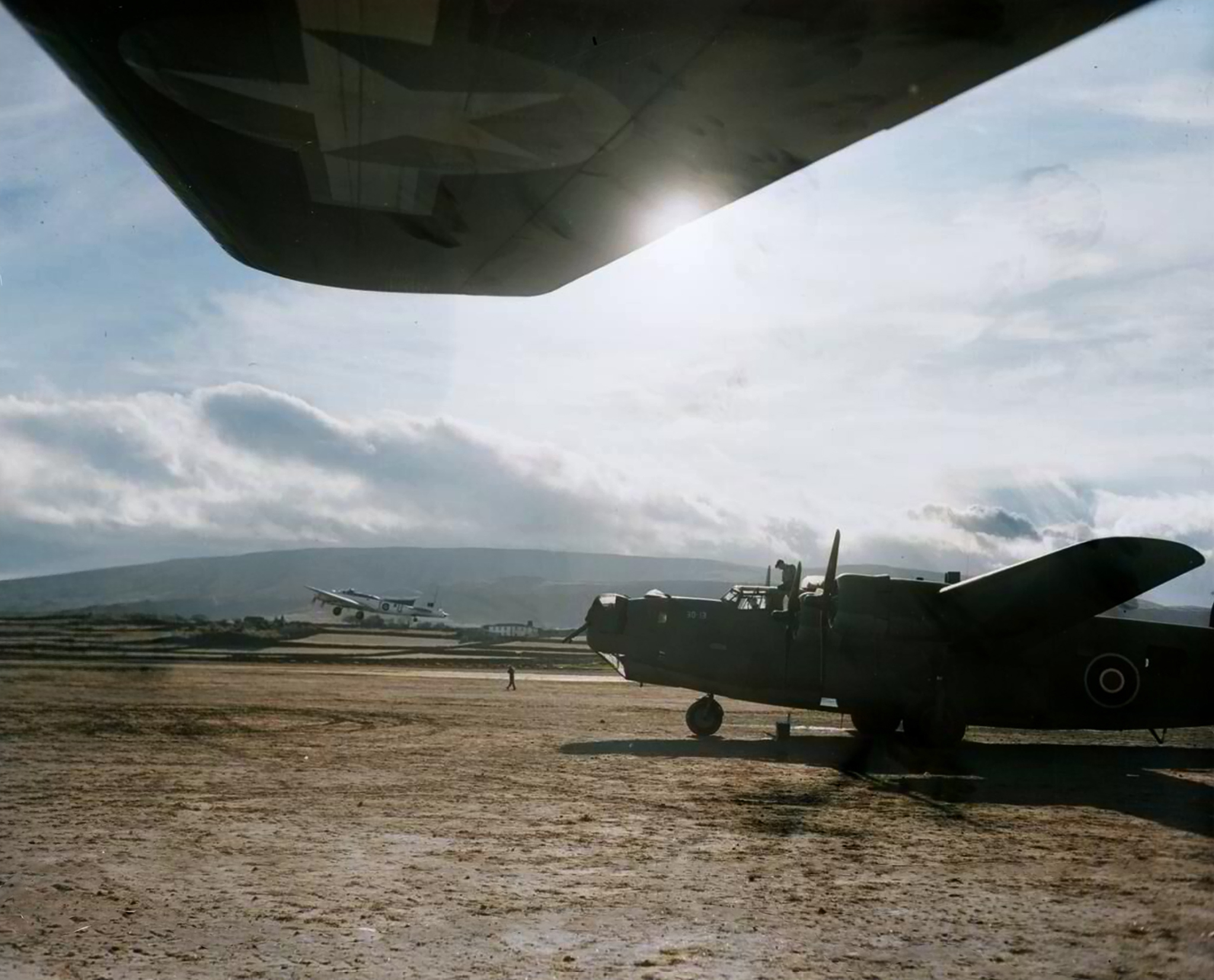 FMS Liberator BVIs RAF parked by the Transport Command Douglas C 54A Skymaster at Lagens with a RAF 206Sqn B 17 Fortress off the main runway 01