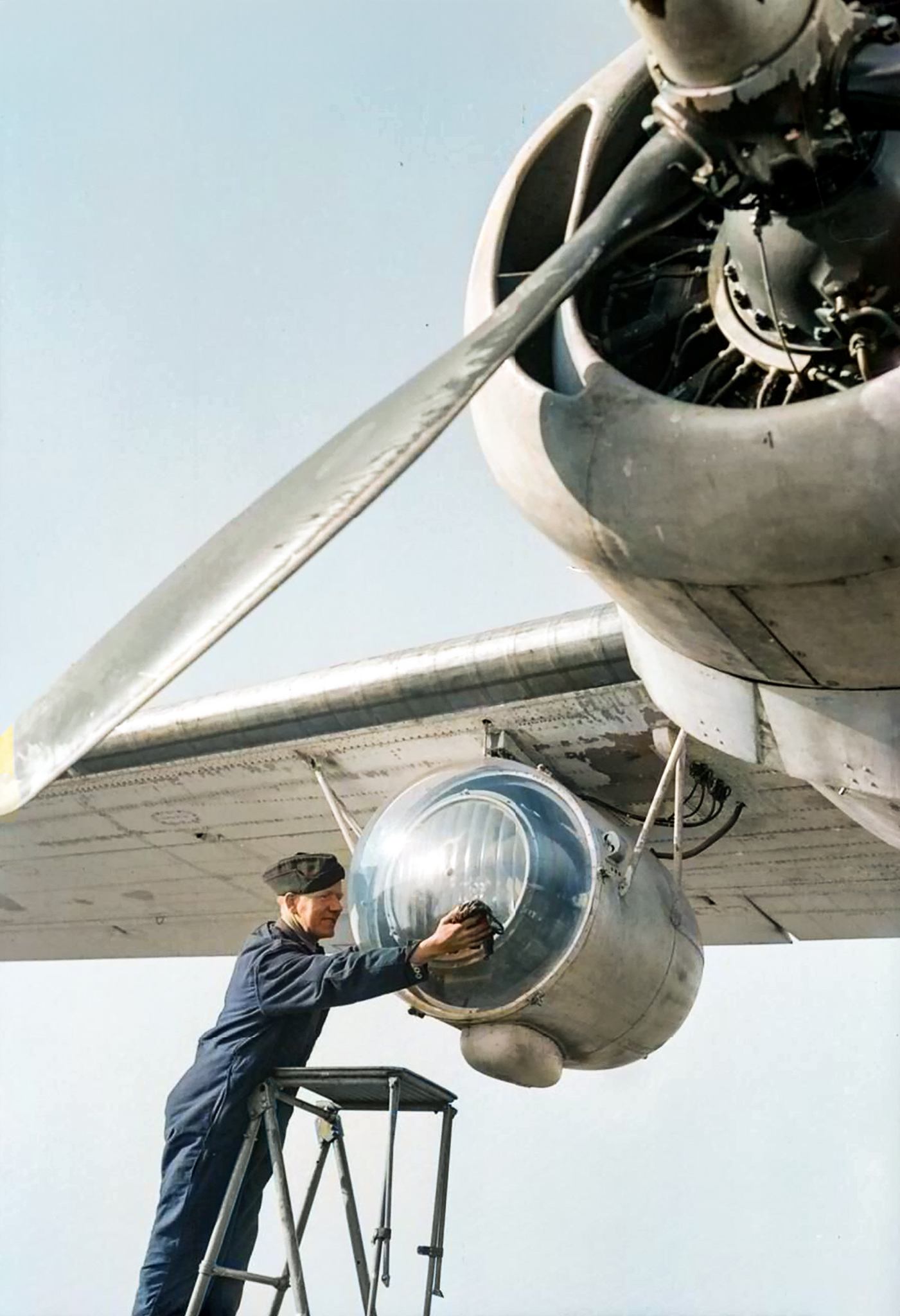 FMS Liberator GRV RAF ground crew member cleaning the plexiglass covering of a Leigh Light based at St Eval Cornwall 1944 IWM CH13998