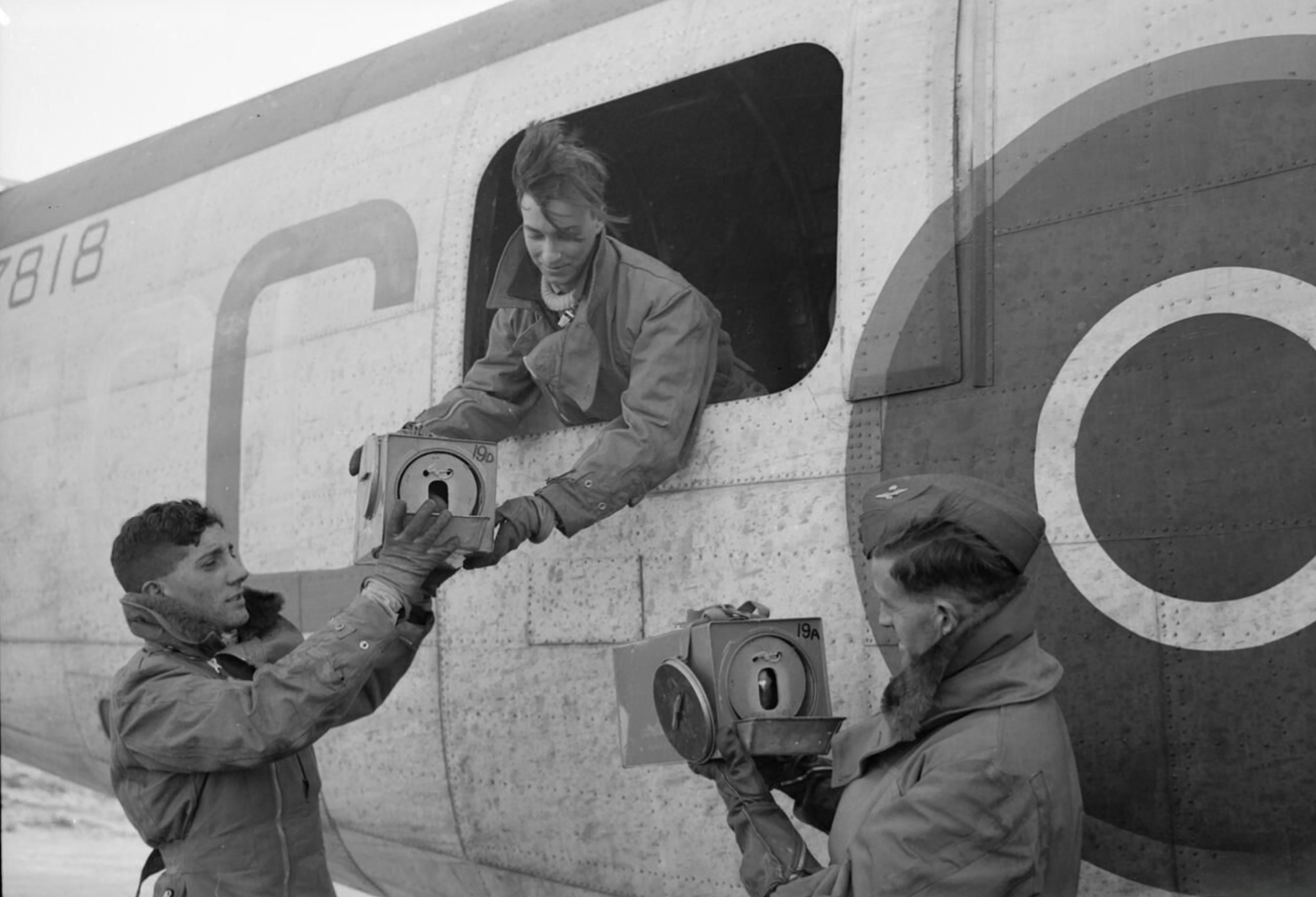 FMS Liberator GRVa RAF 53Sqn C BZ818 being handed containers with homing pigeons based at St Eval Cornwall 1944 IWM CH12364