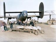 Asisbiz FMS Liberator BII RAF 108Sqn AL574 O with armourers hauling a trolley of 500 lb Gp bombs based at Fayid Egypt 1942 IWM CM3390