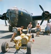Asisbiz FMS Liberator BII RAF 159Sqn Armourers pull a trolley loaded with 500 lb GP bombs at Fayid Egypt 1942 IWM CM3061