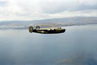 Asisbiz FMS Liberator CII RAF BOAC AL627 flying past the coast of Arran towards Prestwick Ayrshire after a flight across the North Atlantic 1942 IWM