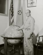 Asisbiz Brigadier General James H Doolittle points to Tokyo on a World globe, sometime after his return to the United States USAF K104