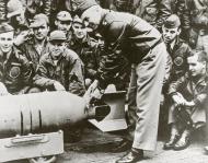 Asisbiz LtCol James H Doolittle USAAF leader of the raiding force wires a Japanese medal to a 500 pound bomb 80 G 41191