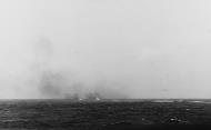 Asisbiz Nashville (CL 43) firing her 6 inch main battery at a Japanese picket boat encountered by the task force 18 April 1942 NH97500