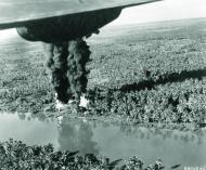 Asisbiz 13AF destroy barge fuel hidden along Borneo jungle waterway near Bandjermasin South Kalimantan Indonesia 1945 NA360