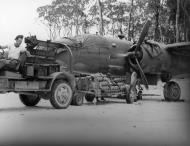 Asisbiz B 25 Mitchell being loaded with One hundred pound demolition bombs Pacific 1943 NA885